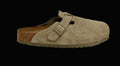 Beige suede clog shoe with a brown sole on a white background